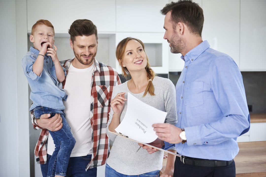 Family and real estate agent in new apartment